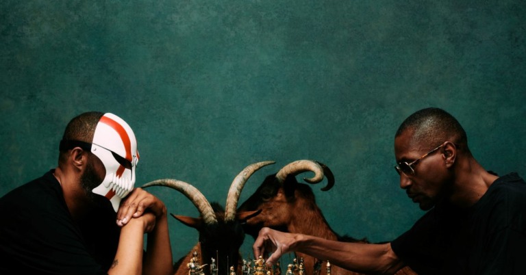 Dany Dan et Kyo Itashi sont assis, ils jouent aux échecs. Il y a deux chèvres derrière eux dans le fond.